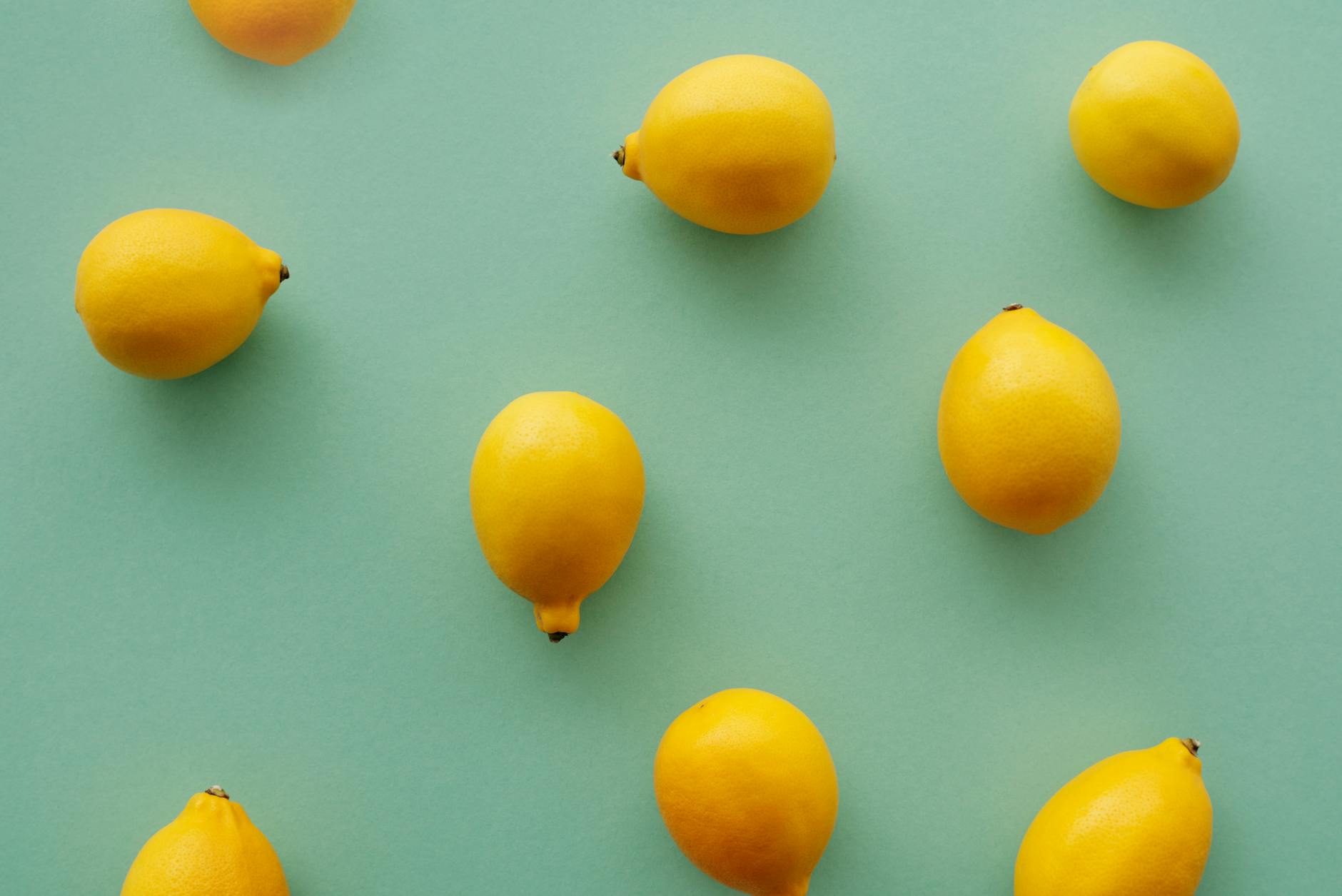 Colorful adult toys arranged on a bright yellow surface, showcasing diverse pleasure tools