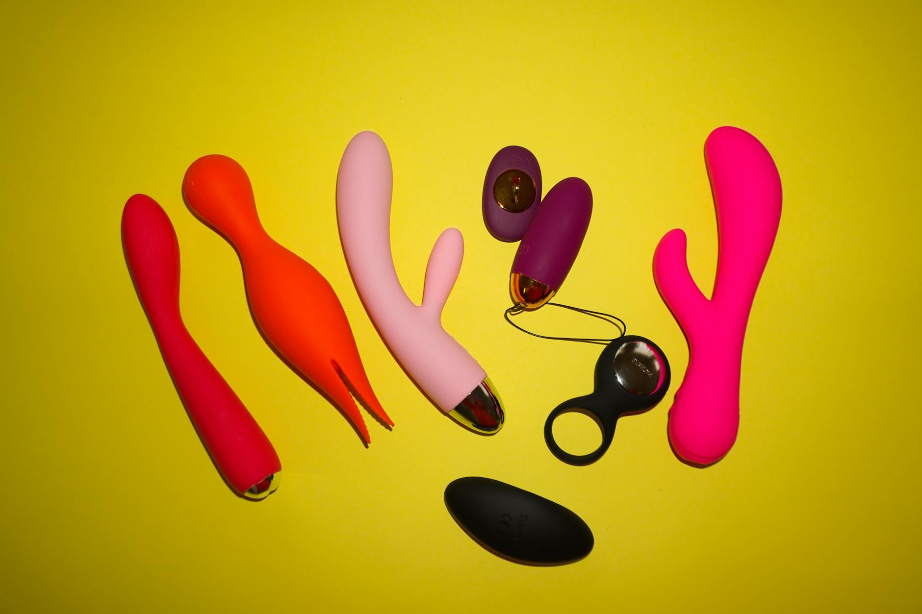 A hand holding a modern vibrator against a minimalist purple backdrop, showcasing gentle sensory stimulation.